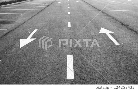 Road with arrows indicating directions in black and white Road with arrows indicating directions in black and white 124258433