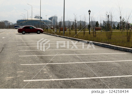 A view of an empty parking lot with a car 124258434