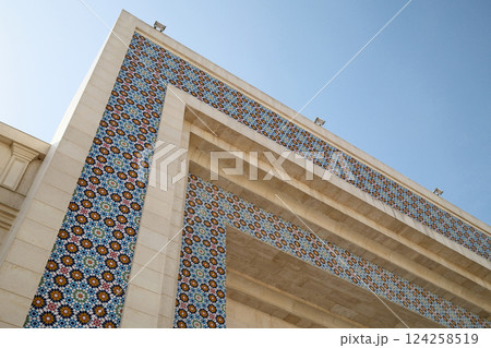 Architectural detail with mosaic tiles and clear sky 124258519