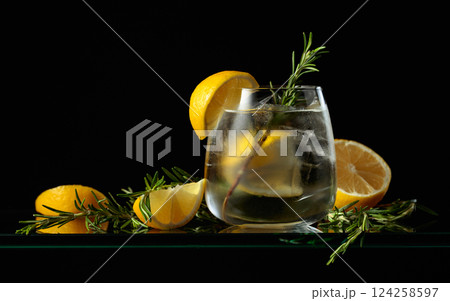 Hard seltzer with ice, lemon, and rosemary. 124258597