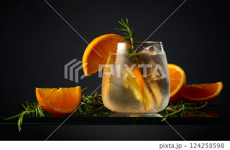 Hard seltzer with ice, orange, and rosemary. 124258598