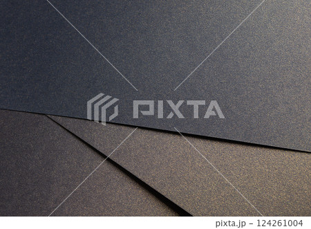 Elegant paper texture with a rich blend of blue, black, and golden tones. Shimmering, grainy surface 124261004