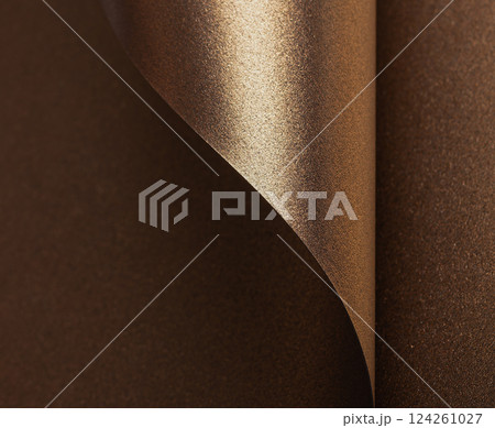 Elegant gold and bronze paper background with a glossy, pearlescent texture. Shimmering metallic 124261027