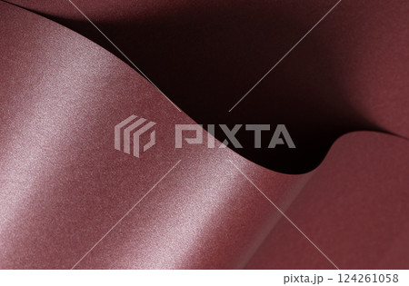 Elegant dark burgundy paper texture with a pearlescent shimmer and glossy finish. Rich and Elegant dark burgundy paper texture with a pearlescent shimmer and glossy finish. Rich and 124261058