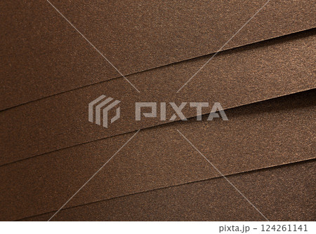 Brown paper background with a matte texture and subtle pearlescent shimmer. Warm, gold and bronze Brown paper background with a matte texture and subtle pearlescent shimmer. Warm, gold and bronze 124261141