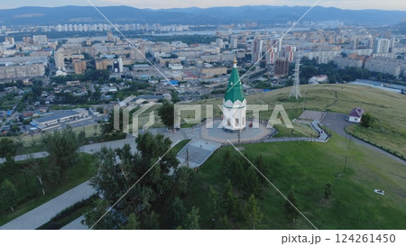 Aerial view of paraskeva pyatnitsa chapel on karaulnaya hill, providing a scenic overlook of krasnoyarsk city during sunset Aerial view of paraskeva pyatnitsa chapel on karaulnaya hill, providing a scenic overlook of krasnoyarsk city during sunset 124261450