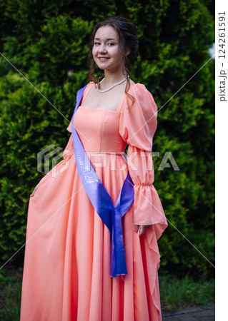 Jubilant female graduate wearing academic sash and formal attire, commemorating academic achievement with infectious joy Jubilant female graduate wearing academic sash and formal attire, commemorating academic achievement with infectious joy 124261591