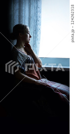 Disabled person in stroller by window 124262318