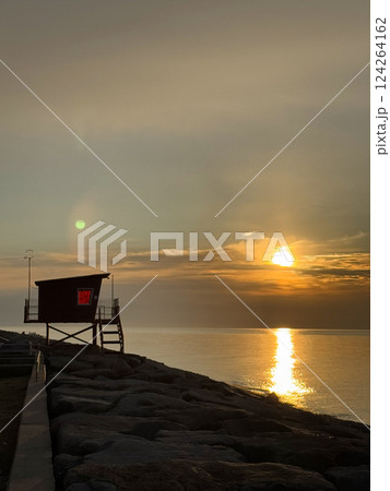 Lifeguard Hut Overlooking Ocean at Golden Sunset 124264162