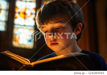 Young Kid Focused on Bible in Quiet Church Young Kid Focused on Bible in Quiet Church 124264563