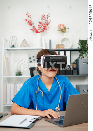 Medical professional wearing VR headset, exploring virtual reality technology for training in a healthcare environment. 124266012