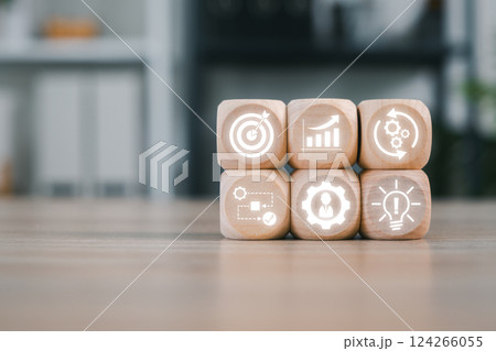 Wooden blocks with icons symbolize business process management, showcasing strategy, innovation, and workflow optimization. Wooden blocks with icons symbolize business process management, showcasing strategy, innovation, and workflow optimization. 124266055