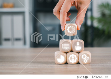 Wooden blocks with digital icons representing asset management, organization, and workflow efficiency. Wooden blocks with digital icons representing asset management, organization, and workflow efficiency. 124266056