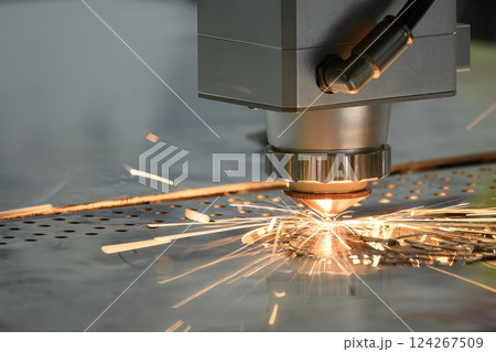 The fiber laser cutting machine  cut the metal plate with the sparkling light. 124267509