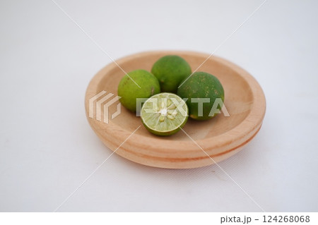 Green lime with cut in half and slices isolated on white background. Green lime with cut in half and slices isolated on white background. 124268068