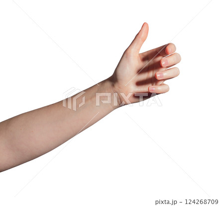 Female hand grasping invisible bottle, gesture symbolizing holding or presenting a product. Natural 124268709