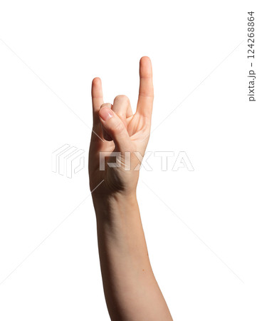 Hand making the rock horns gesture, symbolizing punk, metal, and music culture. Caucasian female 124268864