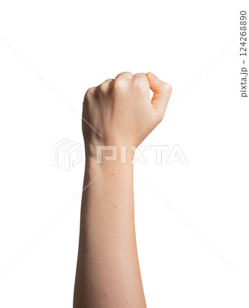 Fist raised, symbol of power and victory. Female hand in clenched position, showing strength and Fist raised, symbol of power and victory. Female hand in clenched position, showing strength and 124268890