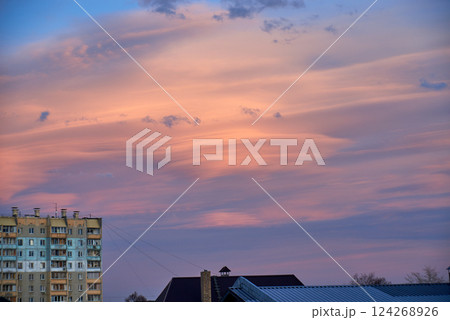 Lenticular round clouds over houses in the city at sunset 124268926