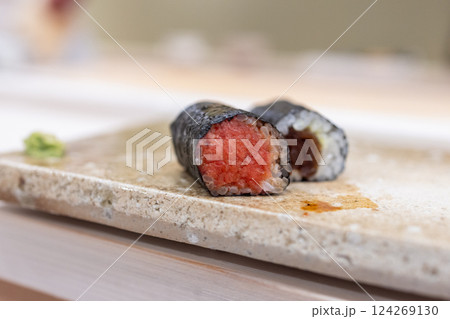 Two hosomaki sushi rolls with finely chopped tuna and dried calabash filling wrapped in nori 124269130