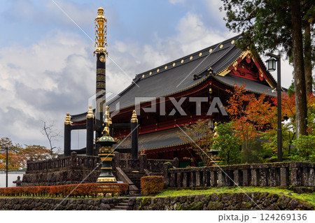 Goma-do Hall in Nikko Japan featuring a black and gold Buddhist monument in the foreground Goma-do Hall in Nikko Japan featuring a black and gold Buddhist monument in the foreground 124269136