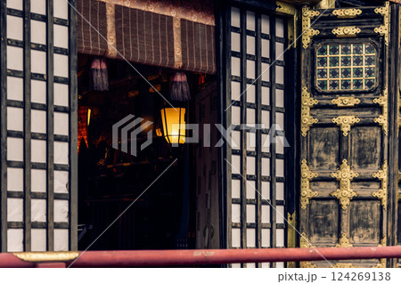 Open wooden door of Gohonsha at Toshogu Shrine, Nikko Japan revealing softly glowing lantern inside 124269138