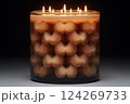 A candle with multiple wicks glows warmly against a dark backdrop, showcasing an eye-catching pattern of rounded shapes that enhances its aesthetic appeal Generative AI 124269733