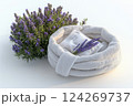 A soft white basket containing a towel and lavender stalks rests beside a thriving lavender plant, creating a tranquil atmosphere ideal for relaxation Generative AI 124269737