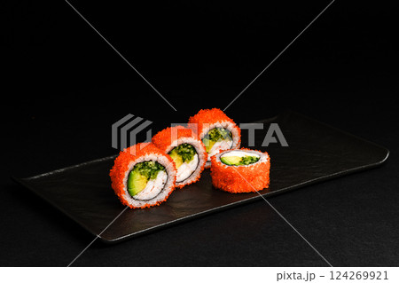 Delicious Fresh Salmon Sushi Rolls Presenting Exquisitely on a Black Background Delicious Fresh Salmon Sushi Rolls Presenting Exquisitely on a Black Background 124269921