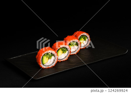 Delicious Fresh Salmon Sushi Rolls Presenting Exquisitely on a Black Background 124269924
