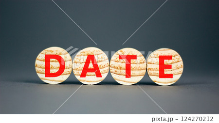 Date symbol. Concept word Date on beautiful wooden circles. Beautiful grey table grey background. Business and date concept. Copy space. Date symbol. Concept word Date on beautiful wooden circles. Beautiful grey table grey background. Business and date concept. Copy space. 124270212