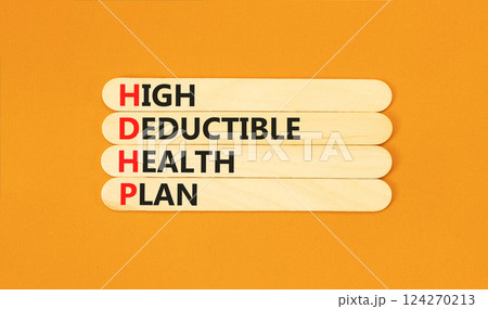 HDHP High Deductible Health Plan symbol. Concept word HDHP High Deductible Health Plan on beautiful sticks. Beautiful orange background. Business HDHP High Deductible Health Plan concept. Copy space. 124270213