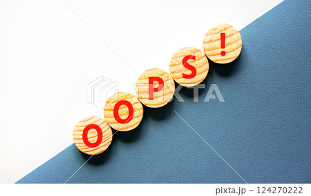 Oops symbol. Concept word Oops on beautiful wooden circles. Beautiful blue and white background. Business lifestyle oops concept. Copy space. Oops symbol. Concept word Oops on beautiful wooden circles. Beautiful blue and white background. Business lifestyle oops concept. Copy space. 124270222