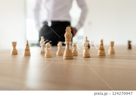 Chess pieces with king in the leading position placed on office desk Chess pieces with king in the leading position placed on office desk 124270947