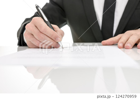Front view of a business man signing a contract Front view of a business man signing a contract 124270959