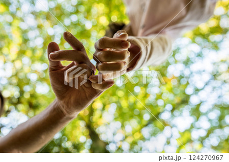 Man and woman walking along with linked fingers in a sign of affection and love Man and woman walking along with linked fingers in a sign of affection and love 124270967