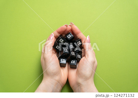 CO2 cubes in hands. Personal carbon footprint. Individual carbon emissions. Environmental impact. Climate change awareness, air pollution concerns. Eco-conscious habits. Environmental responsibility 124271132