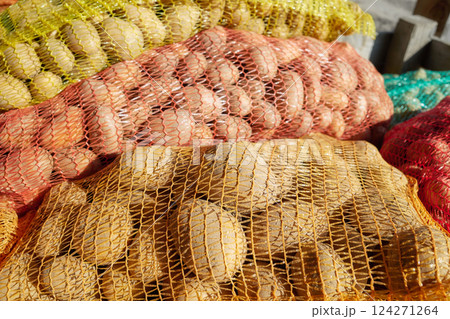 Organic potatoes in net bags, selective focus. Organic potatoes in net bags, selective focus. 124271264