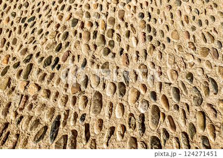 Texture of an old, worn stone floor with a rustic, rough appearance. 124271451