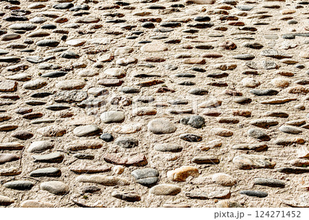 Texture of an old, worn stone floor with a rustic, rough appearance. Texture of an old, worn stone floor with a rustic, rough appearance. 124271452