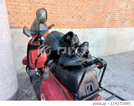 Adventure and travel concept with motorcycle and boots in urban setting 124272895