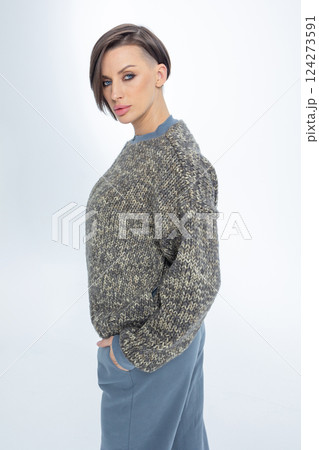 Portrait of young woman warm knitted jumper with zipper on light background. Studio photography. Vertical photo. High quality photo Portrait of young woman warm knitted jumper with zipper on light background. Studio photography. Vertical photo. High quality photo 124273591