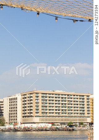 Old town in Al Seef Cultural Historical District. Beautiful view of water, old houses and new ones of Dubai Creek, Dubai, UAE. Taken off hand. Vertical photo. High quality photo Old town in Al Seef Cultural Historical District. Beautiful view of water, old houses and new ones of Dubai Creek, Dubai, UAE. Taken off hand. Vertical photo. High quality photo 124273594
