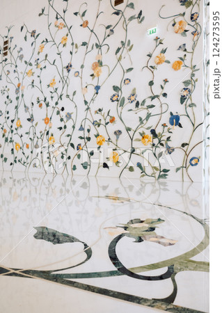View of Sheikh Zayed Grand Mosque in Abu Dhabi made of white marble with flowers made of precious stones in design. Inside mosque. Vertical photo 124273595