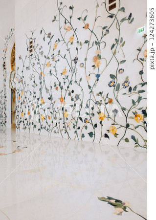 View of Sheikh Zayed Grand Mosque in Abu Dhabi made of white marble with flowers made of precious stones in design. Inside mosque. Vertical photo 124273605