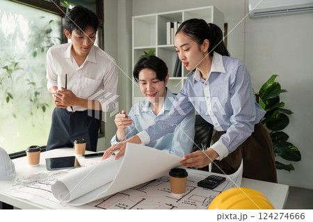 Design and Innovation. Professionals collaborating over building plans and drafts. 124274666