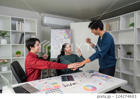 Celebration and Team Success. Team members celebrating a successful project completion. 124274683