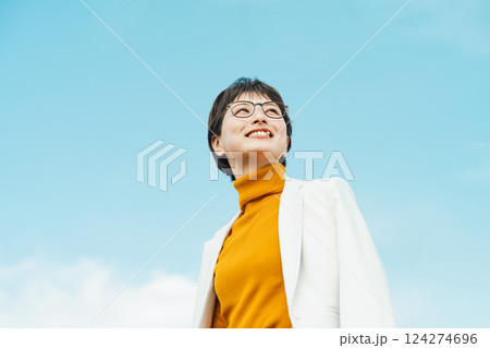 ショートヘアのキャリアウーマンの青空ポートレート 124274696