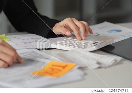 Tax Calculation and Financial Reports. A close-up of tax calculations alongside important documents and a modern calculator. Tax Calculation and Financial Reports. A close-up of tax calculations alongside important documents and a modern calculator. 124274753