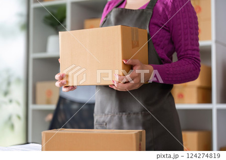 Packing and Shipping Essentials. An online seller preparing a package for shipment. Packing and Shipping Essentials. An online seller preparing a package for shipment. 124274819